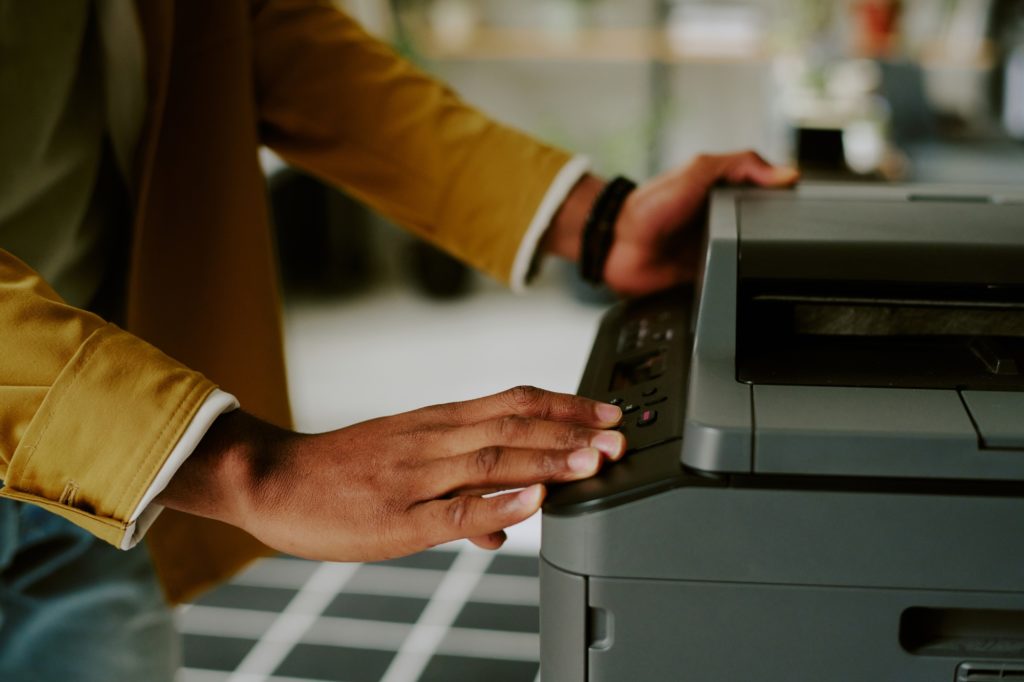 Unrecognizable Man Using Printer